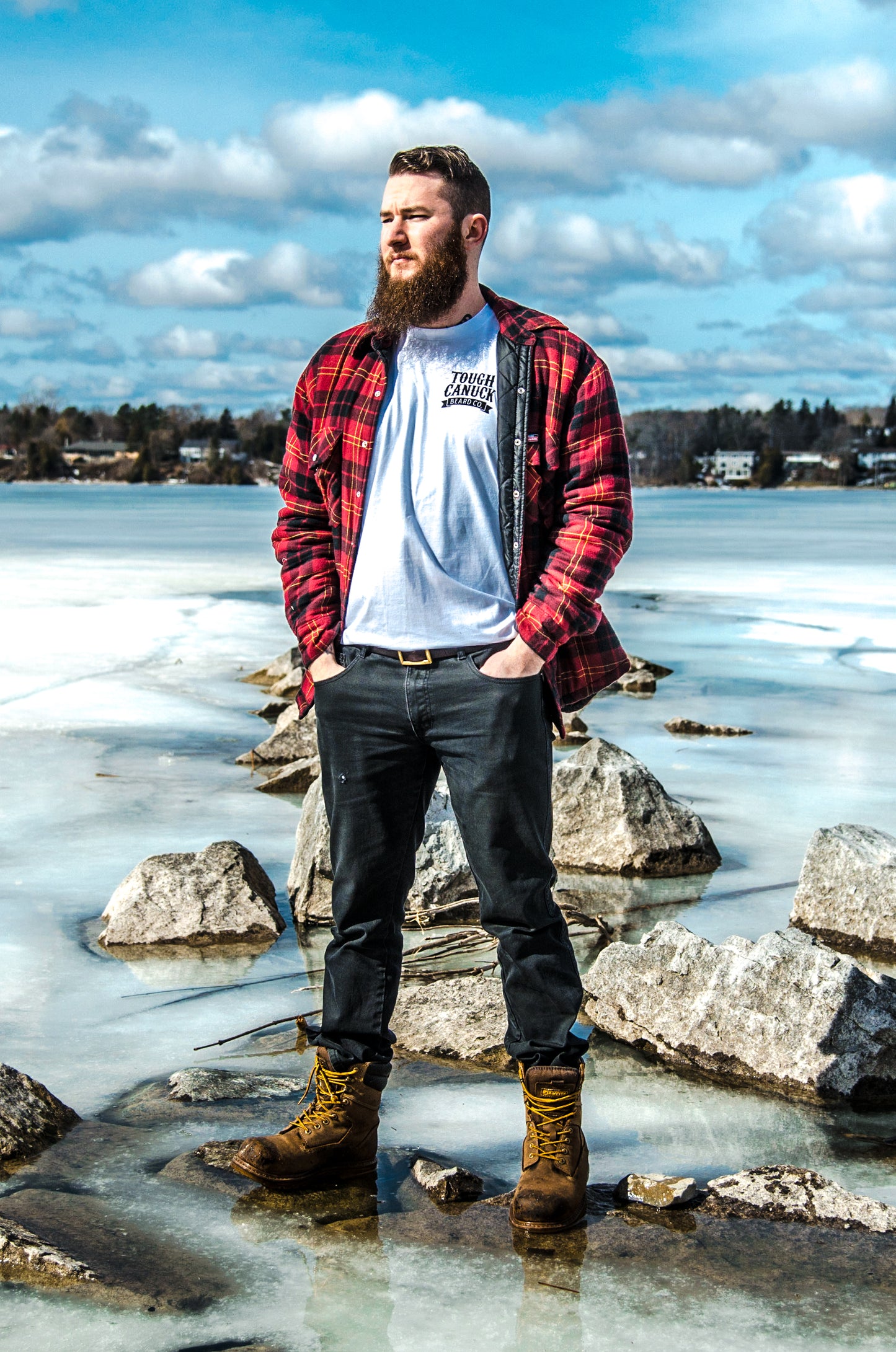 A man looks out over a frozen Lake Ontario in Kingston, ON