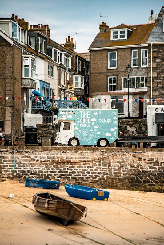 An ice cream truck parked above the break wall in St. Ive's - Cornwall, UK