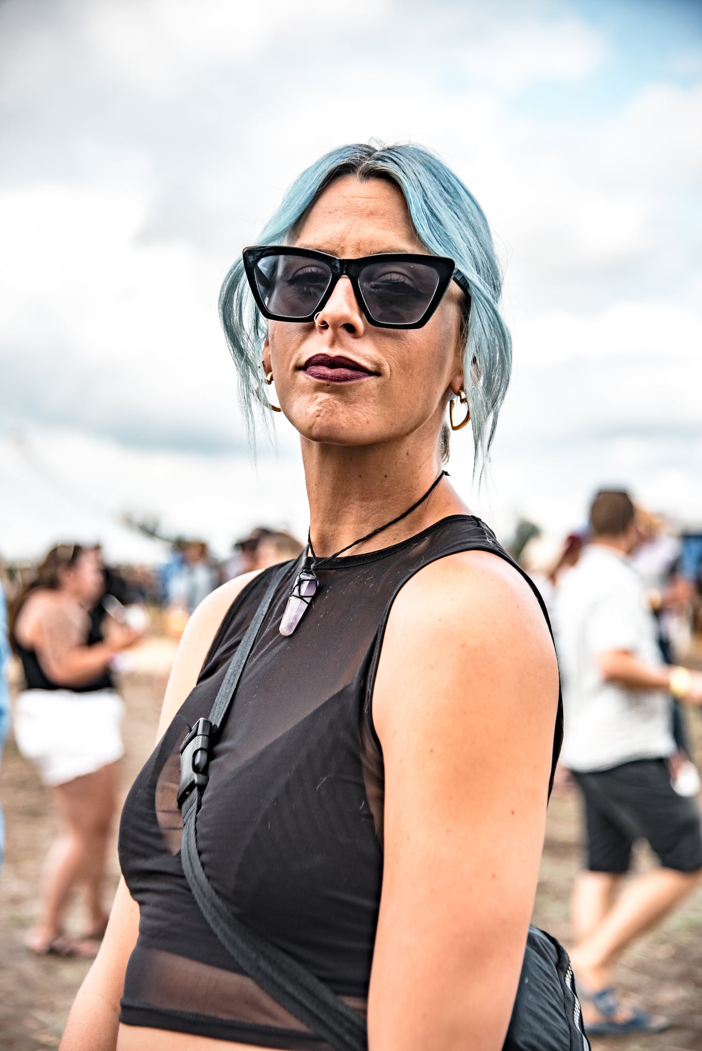 A woman with blue hair smiles at the MacKinnon Brothers' Back to the Farm Beer Festival